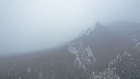 Drone-Aerial-Footage-Flying-Away-From-Flatirons-Mountain-Near-Boulder-Colorado-USA-During-Snowstorm-Blizzard