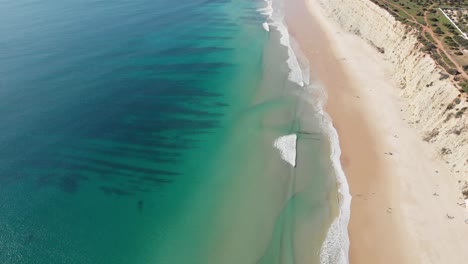 Scenic-coastline-of-Portugal,-turquoise-sea-and-white-sand-beach
