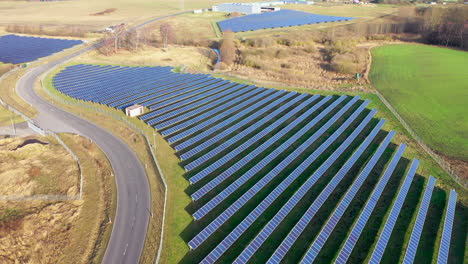 a-drone-flies-over-a-huge-photovoltaic-open-space-installation-consisting-of-many-solar-panels