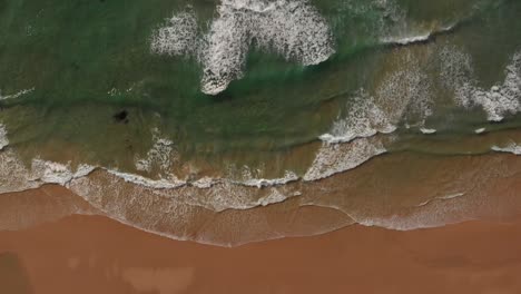 Atlantic-ocean-waves-run-out-on-golden-sand-beach