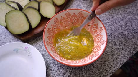 Beating-Fresh-Egg-With-Seasonings-In-A-Bowl-Using-Fork