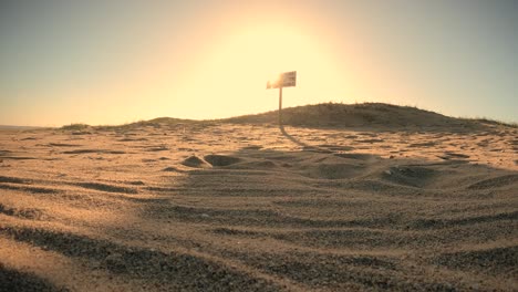 Time-lapse-shot-of-golden-beach-and-no-lifeguard-sign-during-sunset-behind-dunes---Spanish-sign-in-Uruguay