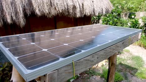 Eco-friendly-sustainable-electric-power-solar-panel-installation-for-a-beach-cabin-home-on-a-remote-tropical-island
