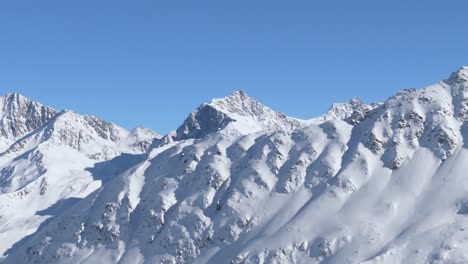 Details-on-rocky-and-snowy-alpine-ridges-in-the-Alps-of-Tyrol---pan-shot