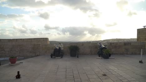 Canons-Facing-City-of-Victoria-From-Cittadella-Fortress-Defensive-Walls-with-Sun-Rays-Shining-Through-Clouds