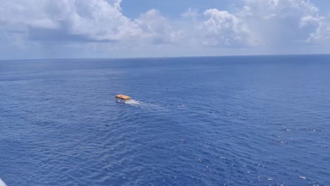 A-lifeboat-of-Cruise-ship-on-a-rescue-mission-in-middle-of-the-Caribbean-ocean-|-Lifeboat-searching-for-something-in-middle-of-the-ocean-on-rescue-mission-in-Caribbean-ocean-video-background-in-4K