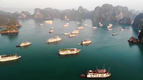 Aerial-view-of-Hạ-Long-Bay,-in-Northeast-Vietnam,-famous-cruise-travel-tourist-destination-known-for-its-emerald-waters-and-thousands-of-limestone-islands-topped-by-rainforests
