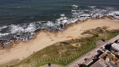 Paraglider-flying-low-altitude-along-La-Pedrera-beach-in-Uruguay