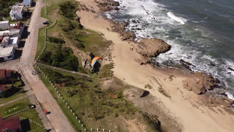 Paraglider-takes-off-from-cliff-and-flies-on-La-Pedrera-beach-in-Uruguay