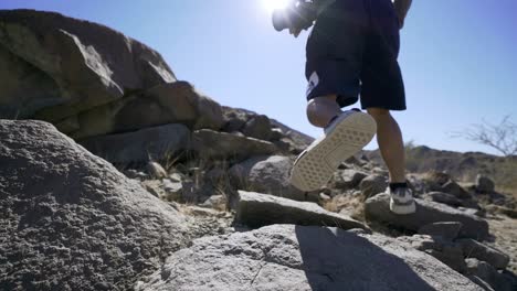 Guy-Vlogger-Man-Climbing-A-Rocky-Mountain-with-Camera-in-Summer-Sunny-Day