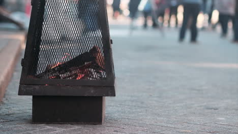 Low-POV-static-shot-of-street-firepit-on-cold-day