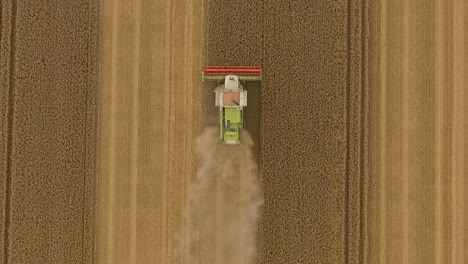 Harvest-drone-fly-upwards-away-from-combine-harvester-over-crop-field