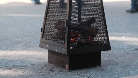 Small-fire-in-portable-firepit-at-street-festival