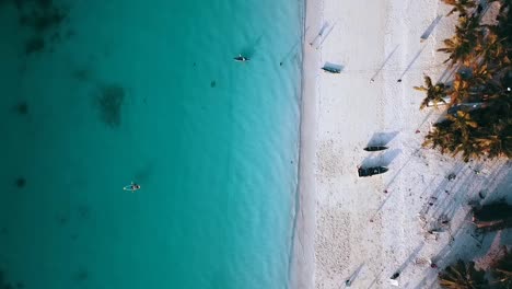 Gorgeous-aerial-flight-bird's-eye-view-drone-shot-of-turquoise-water-white-sand-paradise-dream-beach-and-waves-at-coast-line-in-Zanzibar,-Africa-Tanzania-2019