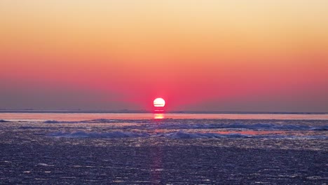 Timelapse-of-Sunrise-Over-Frozen-Water-In-Winter