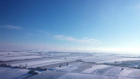 Winterly-Farm-Land-With-Rotating-Wind-Mills-During-Foggy-Morning-In-Weinviertel,-Zistersdorf,-Lower-Austria
