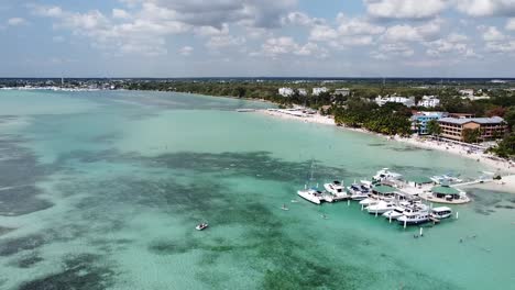DOMINICAN-REPUBLIC---BOCA-CHICA-2022---Aerial-over-tourists-riding-Paddle-Surf-in-the-Boca-Chica-beach-district-in-the-Dominican-Republic