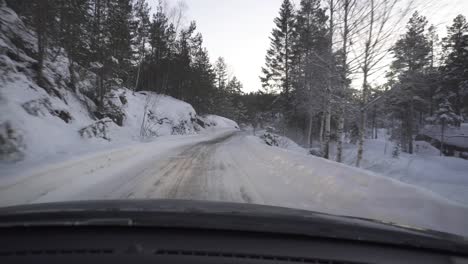 POV-Shot-From-A-Car-Driving-Through-Snowy-Mountain-Road-During-Winter