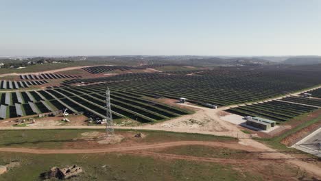 Solar-panels-installed-on-big-solar-farm-in-Algarve,-Portugal---drone-pan