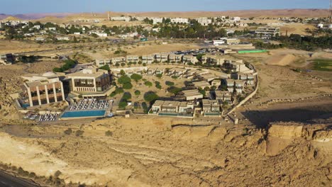 Several-houses-together-in-the-town-of-Mitzpe-Ramon-in-the-dry-Negev-desert-during-golden-hour-on-a-sunny-day-in-Israel