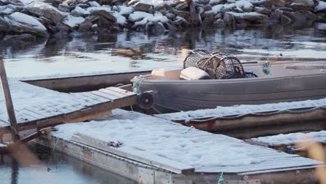 Boat-Moored-At-Snowy-Jetty-During-Winter-In-Norway