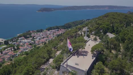 Flying-around-the-flag-while-panning-up-to-the-Adriatic-Sea