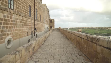 Long-Stone-Path-on-Cittadella-Fortress-Defensive-Wall-on-Bright-Day-with-City-in-Background