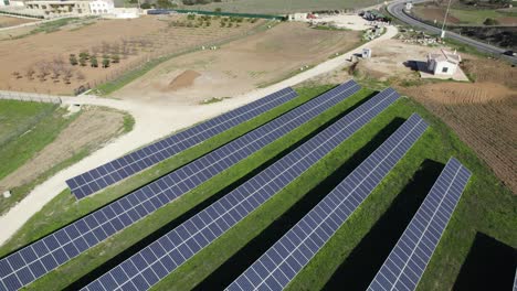 Drone-pullback-reveals-solar-panels-next-to-road-in-countryside,-Portugal