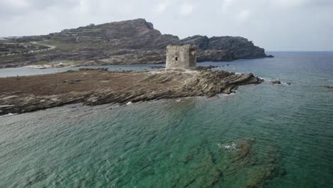 Aerial-fast-low-altitude-orbit-over-the-medieval-Pelosa-watchtower-on-the-rocky-island-surrounded-by-the-emerald-sea