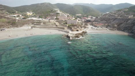 Aerial-establishing-shot-of-the-bay-and-the-beaches-of-a-Cape-Argentiera---former-silver-mines-in-Sardinia,-Italy