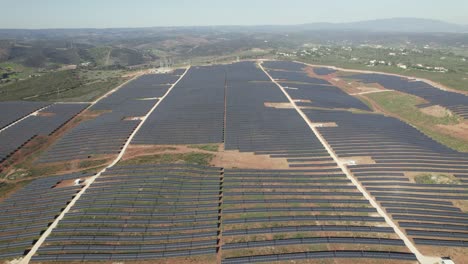 Aerial-high-panoramic-view-energy-solar-farm,-countryside-landscape