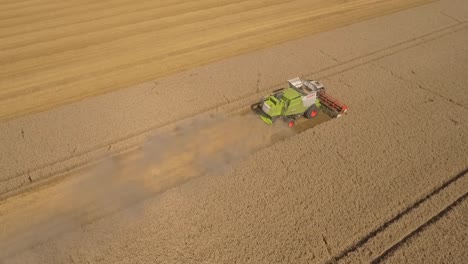 Harvest-half-pivot-tracking-shot-Claas-combine-harvester-in-field