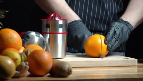 Person-Cut-Fresh-Orange-And-Squeeze-It-Using-Manual-Squeezer
