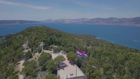 FLying-over-the-flag-of-Croatia,-while-panning-down,-keeping-the-flag-as-the-main-subject