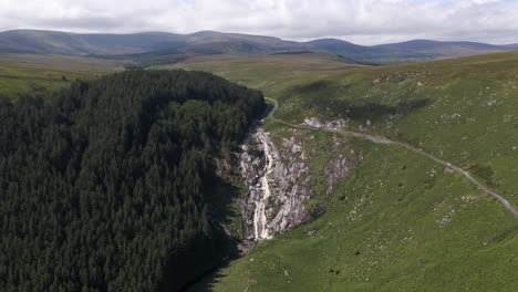 Drone-shot-of-a-large-waterfall-in-Ireland-on-a-sunny-day