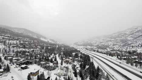 Aerial-Drone-Footage-Flying-Over-Snow-Covered-I-70-Grand-Army-of-the-Republic-Highway-near-Vail-Colorado-USA-During-Cold-White-Winter