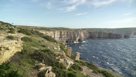 Panoramic-View-of-Mediterranean-Sea-with-Azure-Window-Remains-in-Distance-on-Gozo-Island