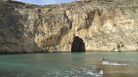 Panorama-of-Inland-Sea-Caves-Area-in-Malta-with-Stone-Piers-Being-Washed-by-Sea-Water