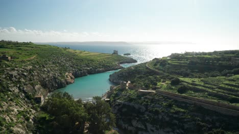 AERIAL:-Small-Isolated-Magrr-Ix-Xini-Bay-on-Sunny-Day-in-Gozo-Island