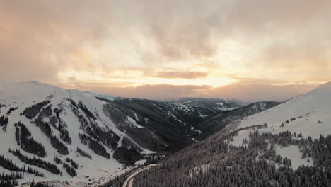 Drone-Aerial-Footage-Flying-Over-Rocky-Mountains-Alpine-Valley-Slopes-Covered-In-Pine-Trees-During-Beautiful-Golden-Hour-Sunset-In-Loveland-Pass,-Colorado-USA