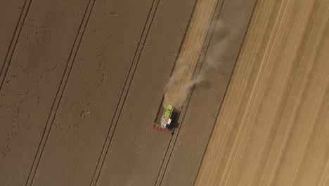 Harvest-drone-topdown-circular-lifting-shot-over-Claas-combine-harvester
