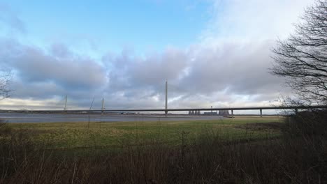 Speeding-clouds-moving-above-motorway-suspension-bridge-over-river-Mersey-estuary