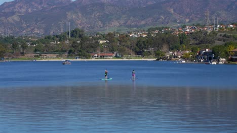 Two-female-paddle-boarders-on-Lake-Mission-Viejo-in-Southern-California