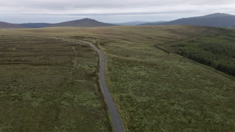 Drone-shot-of-a-mountain-road-with-a-cyclist-on-it