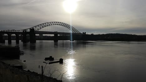 Sunrise-over-industrial-shipwreck-in-shimmering-river-Mersey-under-Silver-Jubilee-bridge