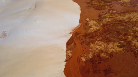 Aerial-birdseye-over-white-and-red-sand-dunes-connecting,-Vietnam