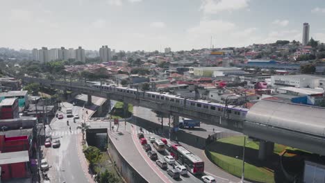 Aerial-landscape-image---Flying-over-slum-subway-rail-in-district-of-Capão-Redondo,-São-Paulo-City-in-Brazil
