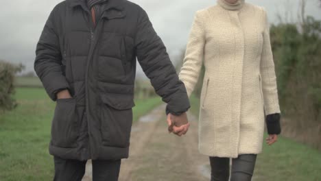 Multiracial-couple-walking-in-the-countryside,-african-and-caucasian-spouses,-multi-ethnic-couple