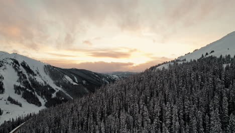 Drone-Aerial-Footage-Flying-Over-Rocky-Mountains-Alpine-Pine-Tree-Mountain-Valley-Slopes-During-Beautiful-Golden-Hour-Sunset-In-Loveland-Pass,-Colorado