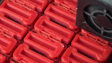 Red-pieces-being-printed-on-a-3D-printer